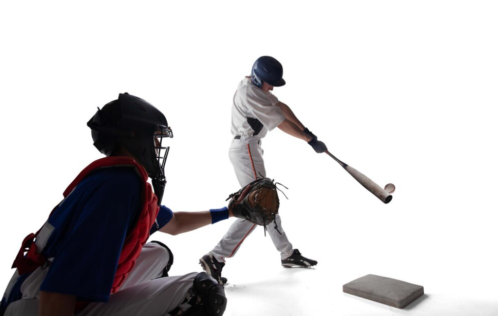 A batter swings at a pitch with a catcher and umpire behind him