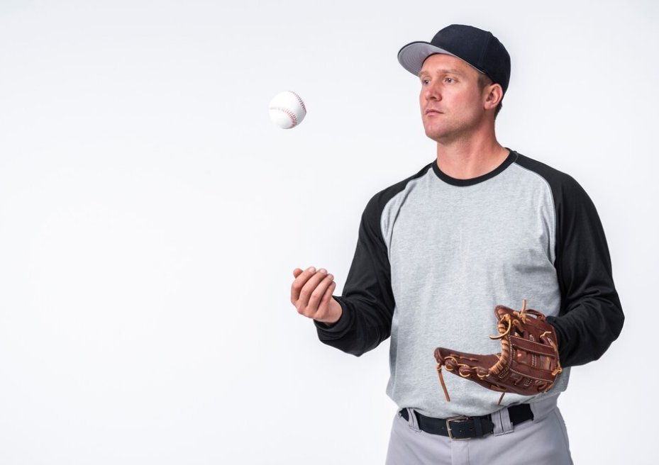 Baseball player catching a ball, wearing a cap and glove