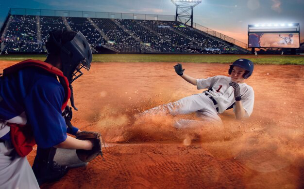 A baseball player rolls across the field