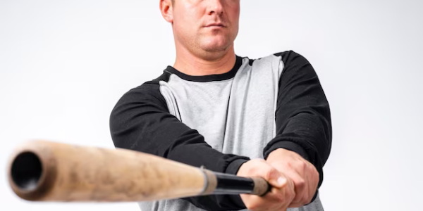 Close-up of a baseball bat with a player