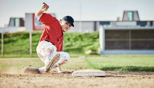 A man slides across a field playing baseball