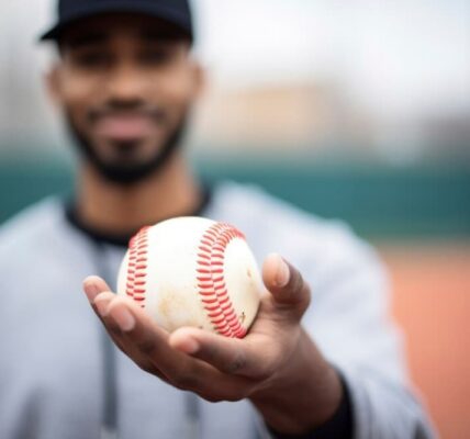 A smiling player offers a baseball, focus on the ball