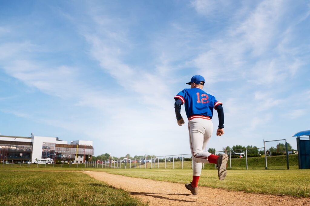 Side view of baseball player running on field