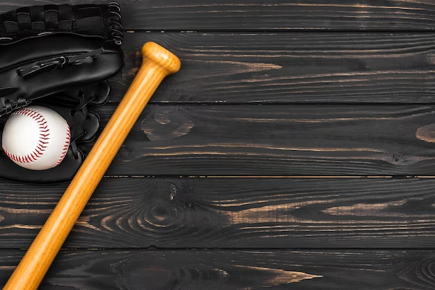 A bat, ball, and glove for playing baseball on a wooden table