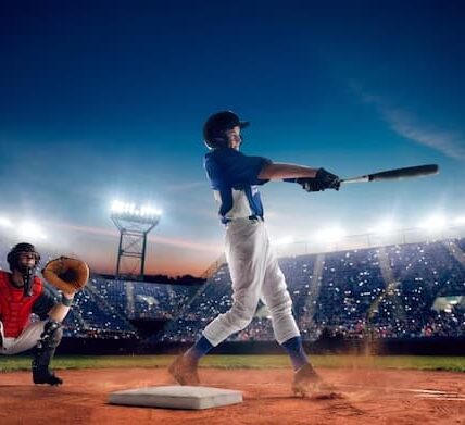 Two men on the field playing baseball with a bat