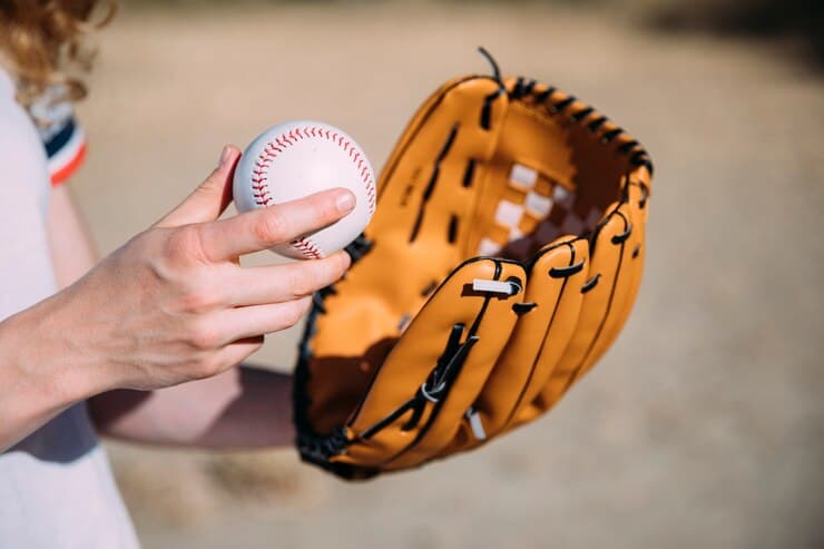 Woman Holding Baseball Glove and Ball