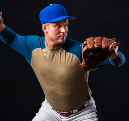 Baseball Player Poses with a glove and a Ball