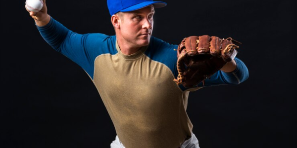 Baseball Player Poses with a glove and a Ball