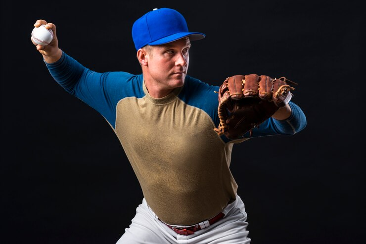 Baseball Player Poses with a glove and a Ball